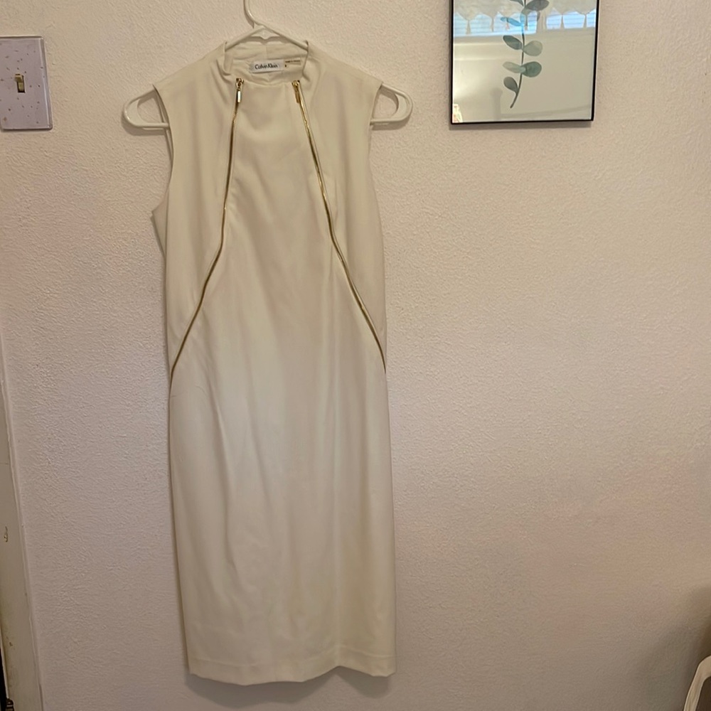 Calvin Klein white dress with zipper details on sides.